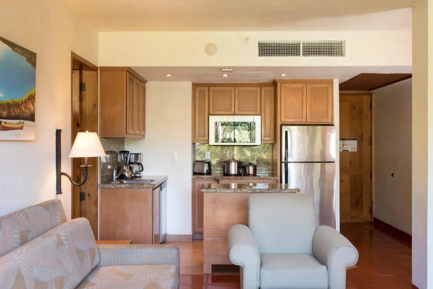 Suite living area with kitchenette and seating at Club Regina Puerto Vallarta.