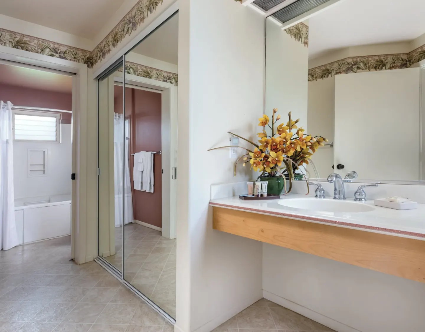 Bathroom vanity with tub area and mirrored closet at Club Wyndham Bali Hai Villas.
