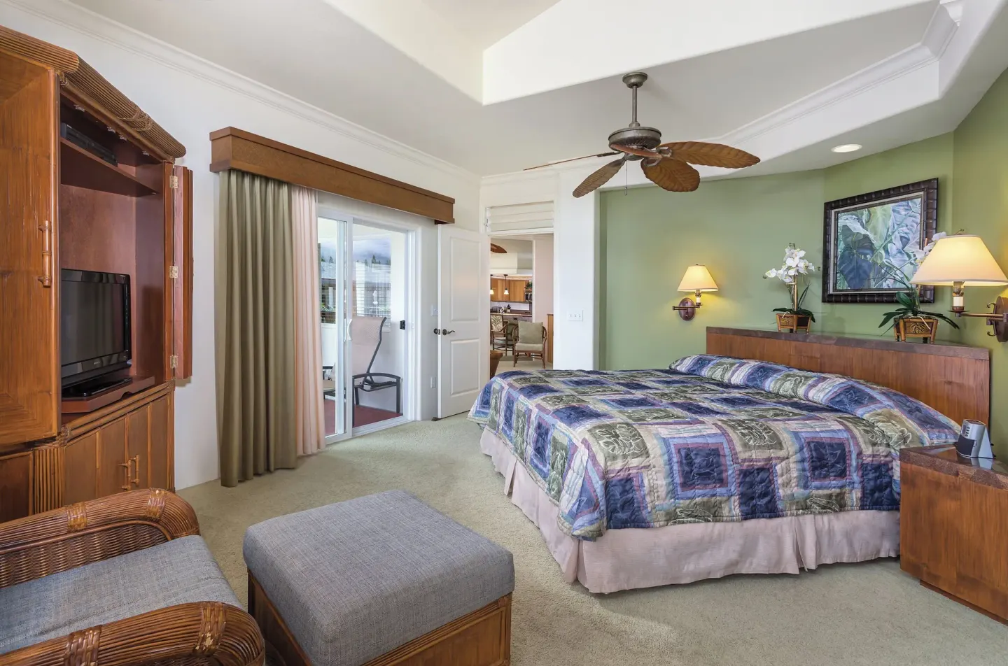 Bedroom with a king bed, seating, and balcony doors at Club Wyndham Bali Hai Villas.