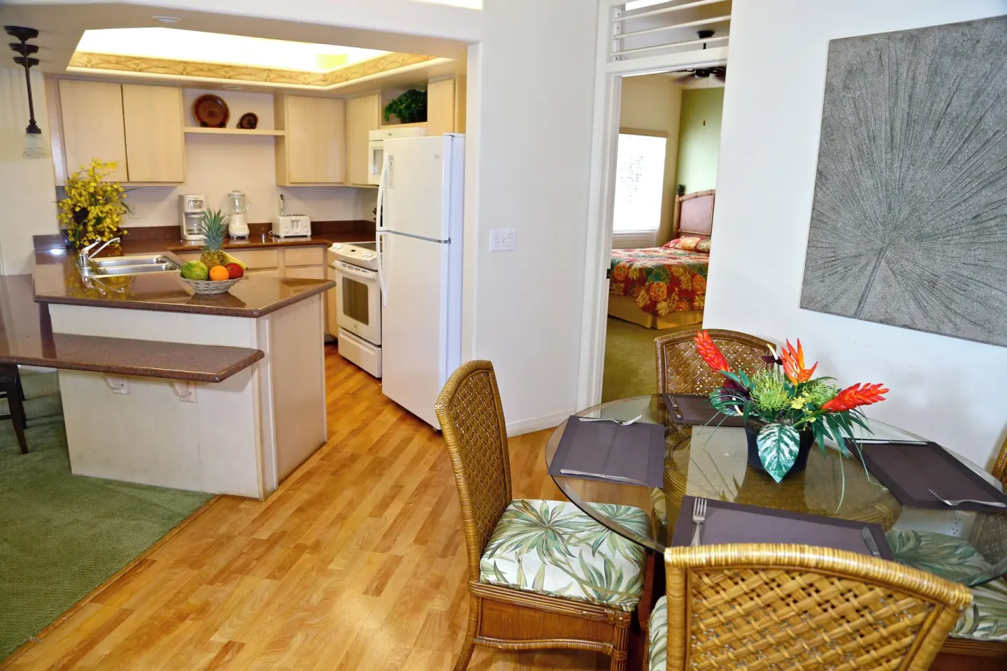 Dining table beside an open kitchen and bedroom doorway at Club Wyndham Bali Hai Villas.
