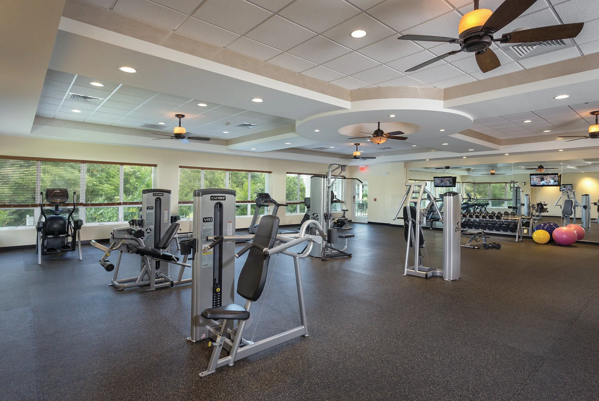 Fitness room with cardio machines, weights, and ceiling fans at Club Wyndham Bali Hai Villas.