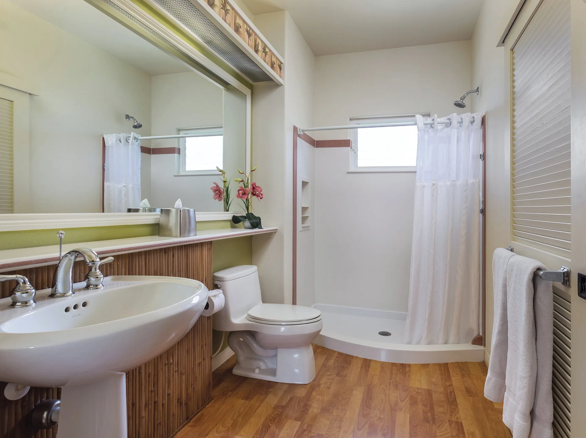 Guest bathroom with sink, toilet and walk-in shower at Club Wyndham Bali Hai Villas.