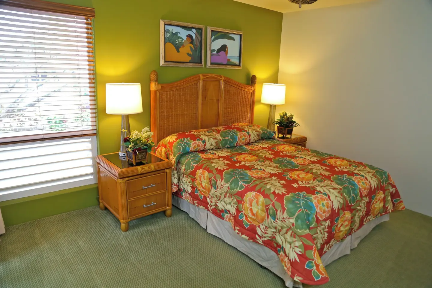 Guest bedroom with floral bedding, green wall, and bedside lamps at Club Wyndham Bali Hai Villas.