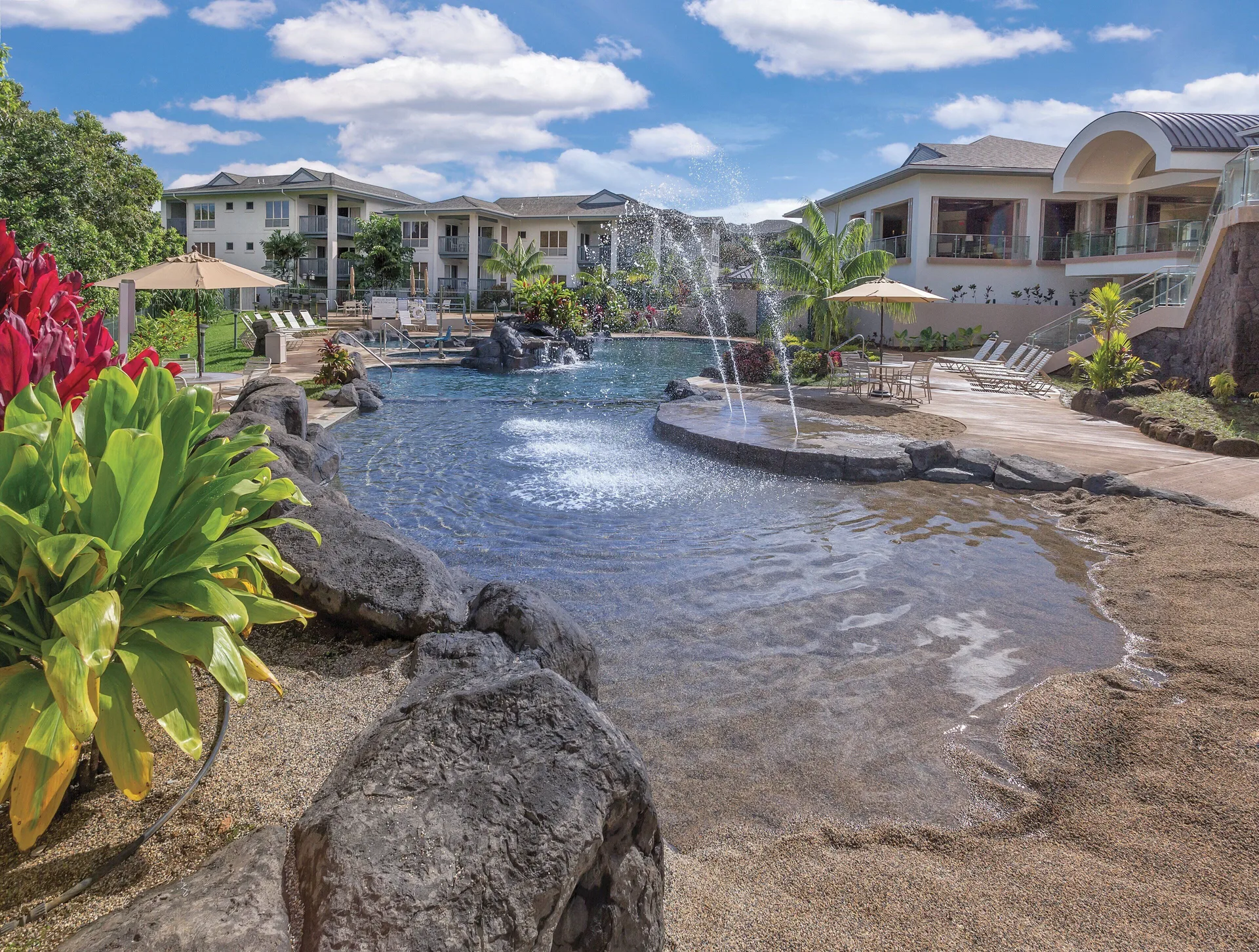 Lagoon pool with fountains, rock edging, and lounge chairs at Club Wyndham Bali Hai Villas.
