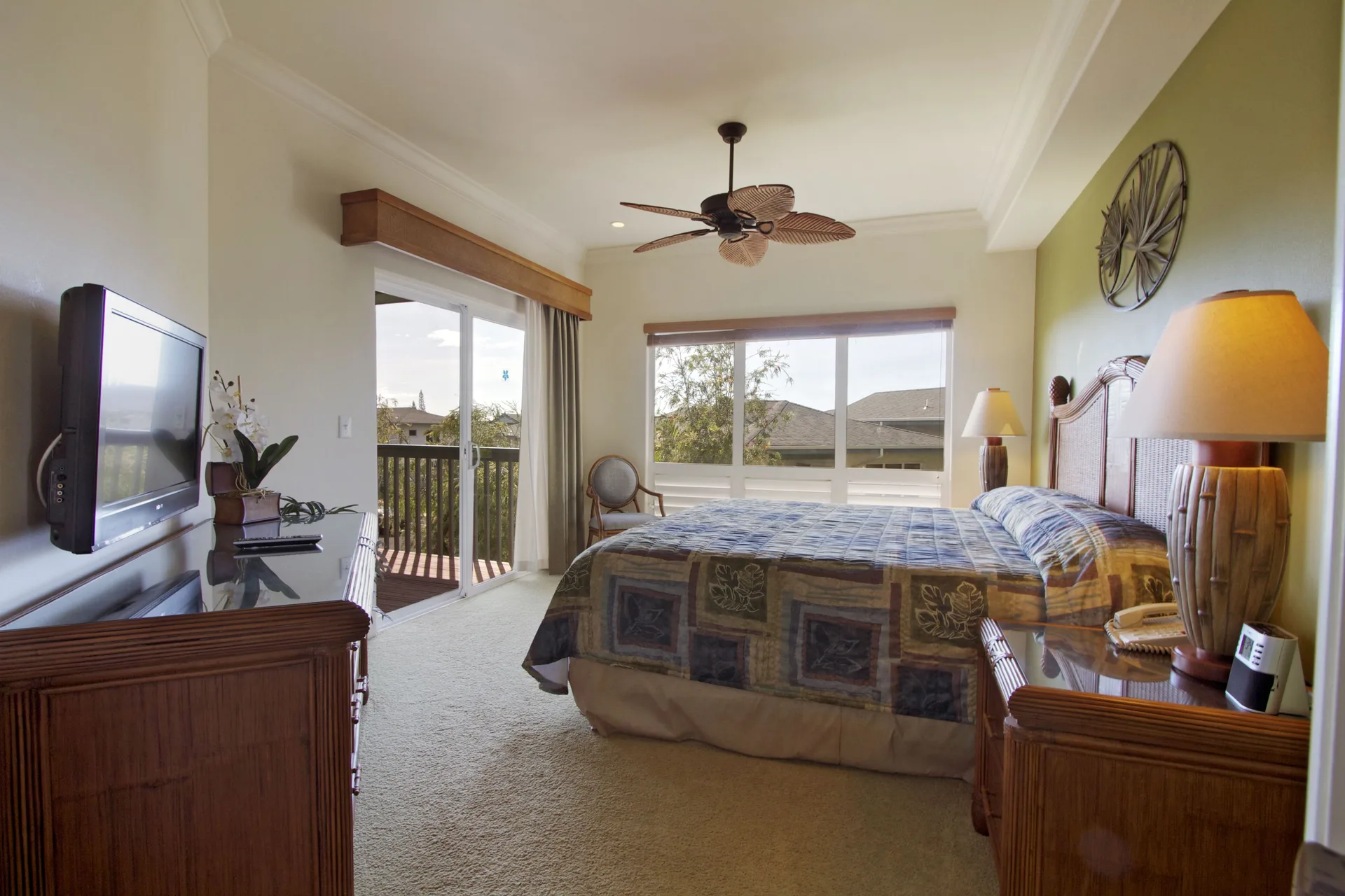 Two-bedroom suite bedroom with king bed and balcony at Club Wyndham Bali Hai Villas.