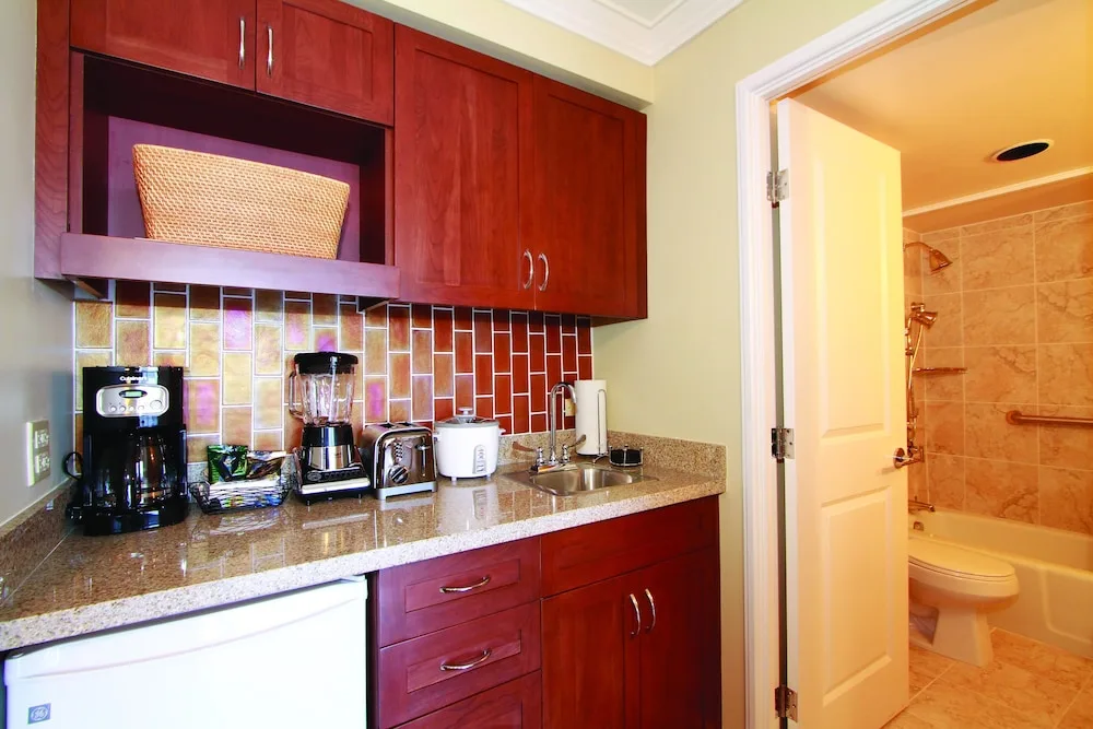 Guest room kitchenette and bathroom at Club Wyndham Royal Garden at Waikiki.