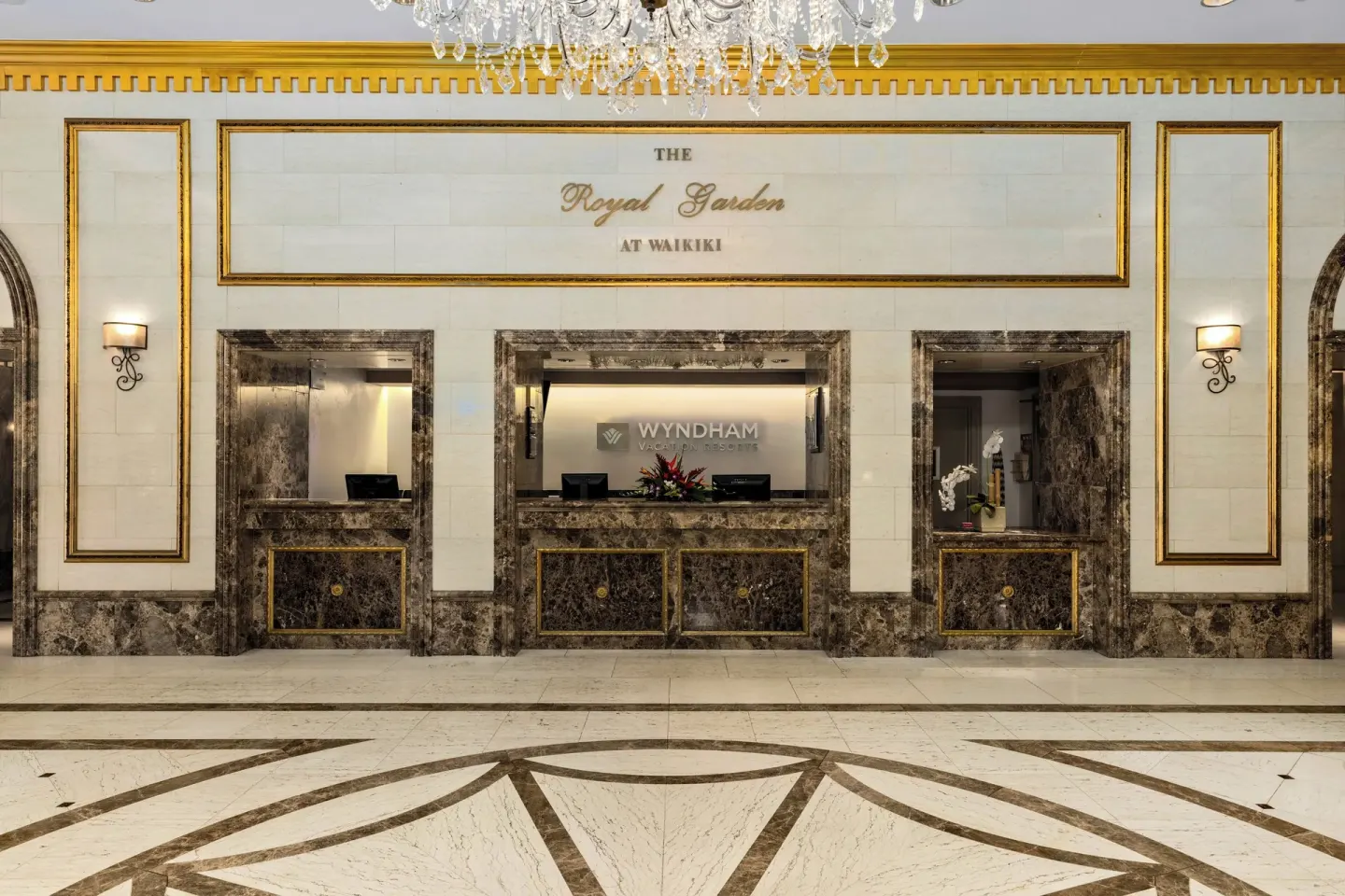 Reception desks and chandelier in the lobby at Club Wyndham Royal Garden at Waikiki.
