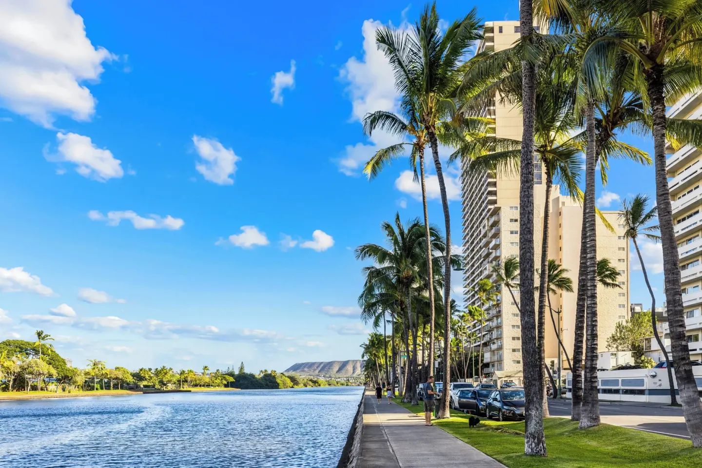 Palm-lined canal walkway near Club Wyndham Royal Garden at Waikiki with Diamond Head in the distance.