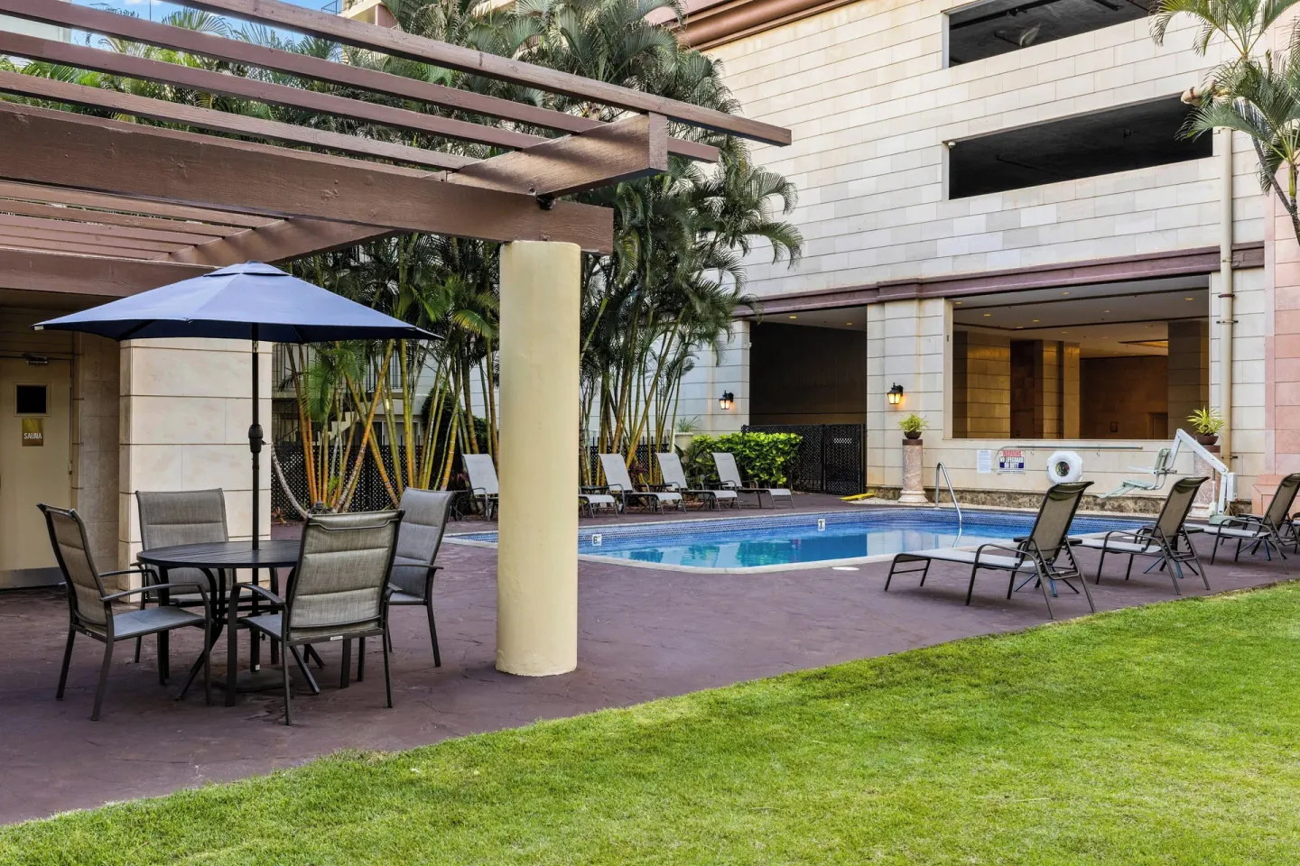 Pool terrace with umbrella table at Club Wyndham Royal Garden at Waikiki.