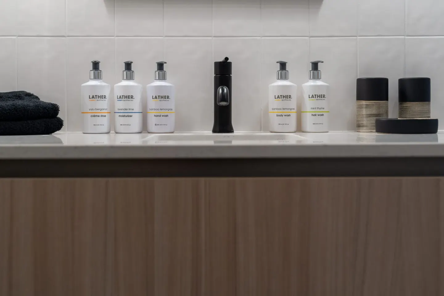 Bathroom counter with towels and pump bottles at Cobalt Coast Resort.