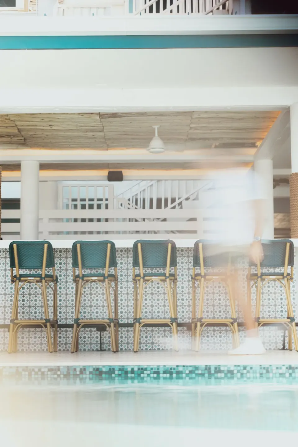 Poolside bar stools and patterned tile at Cobalt Coast Resort.