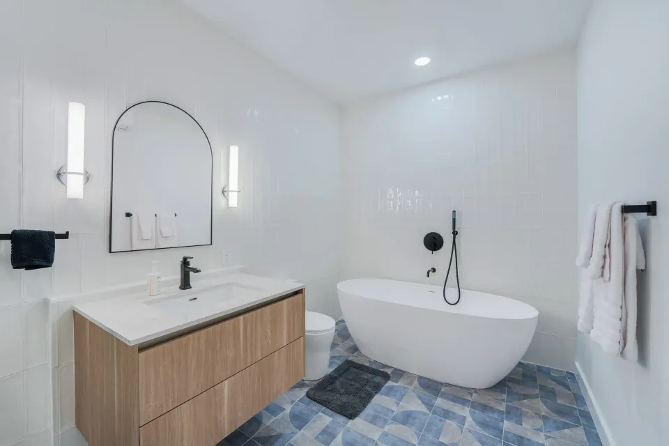 Deluxe Room bathroom with soaking tub and vanity at Cobalt Coast Resort.