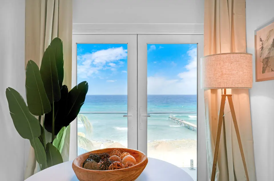 Corner Ocean View room doors framing the beach and sea at Cobalt Coast Resort.