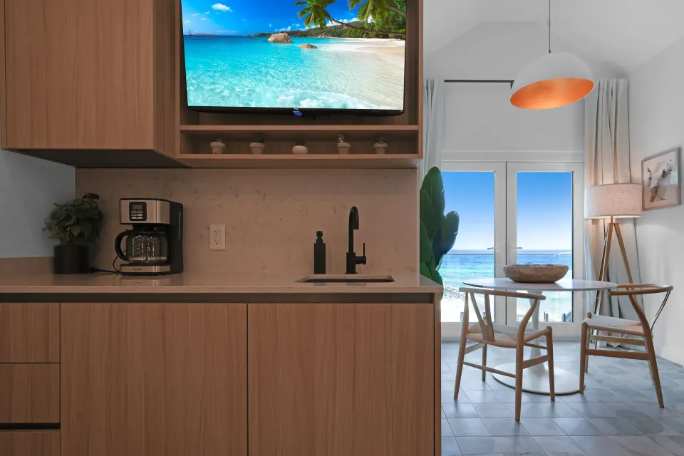 Corner Ocean View kitchenette and dining nook beside ocean-facing doors at Cobalt Coast Resort.