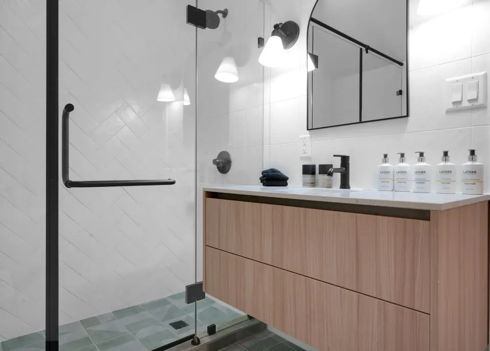 Ocean View room bathroom with glass shower and vanity at Cobalt Coast Resort.