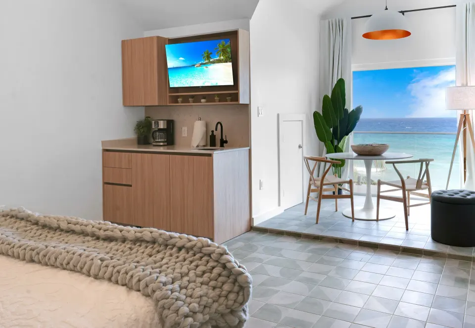 Ocean View room kitchenette, bed, and dining nook at Cobalt Coast Resort.