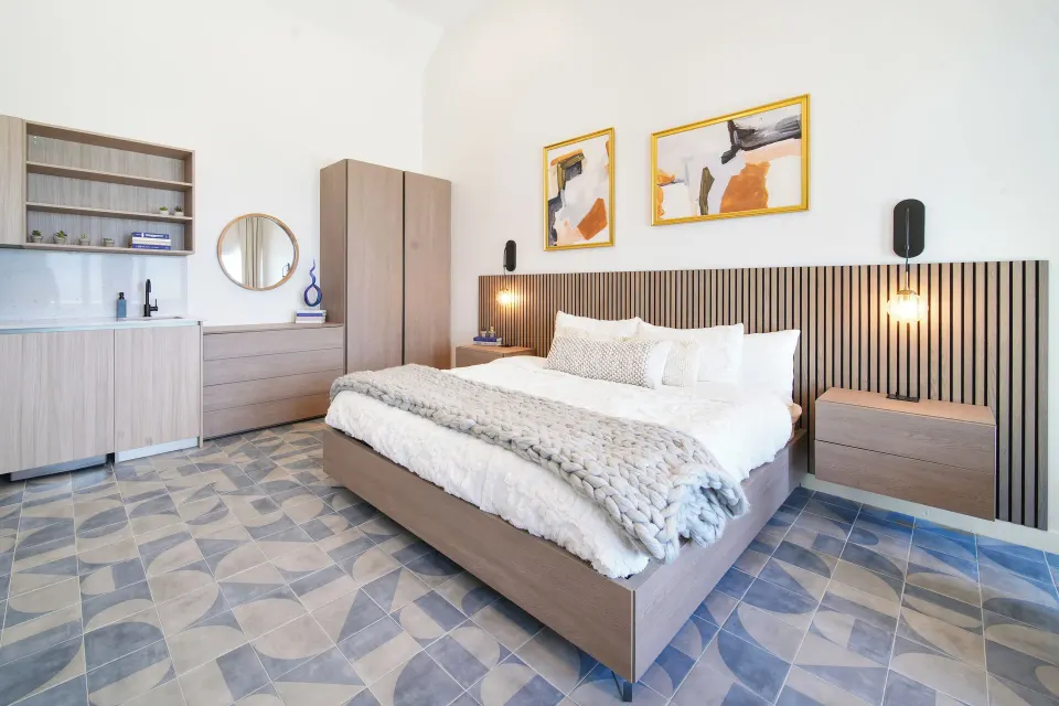 Ocean View room king bed with kitchenette and wardrobe at Cobalt Coast Resort.