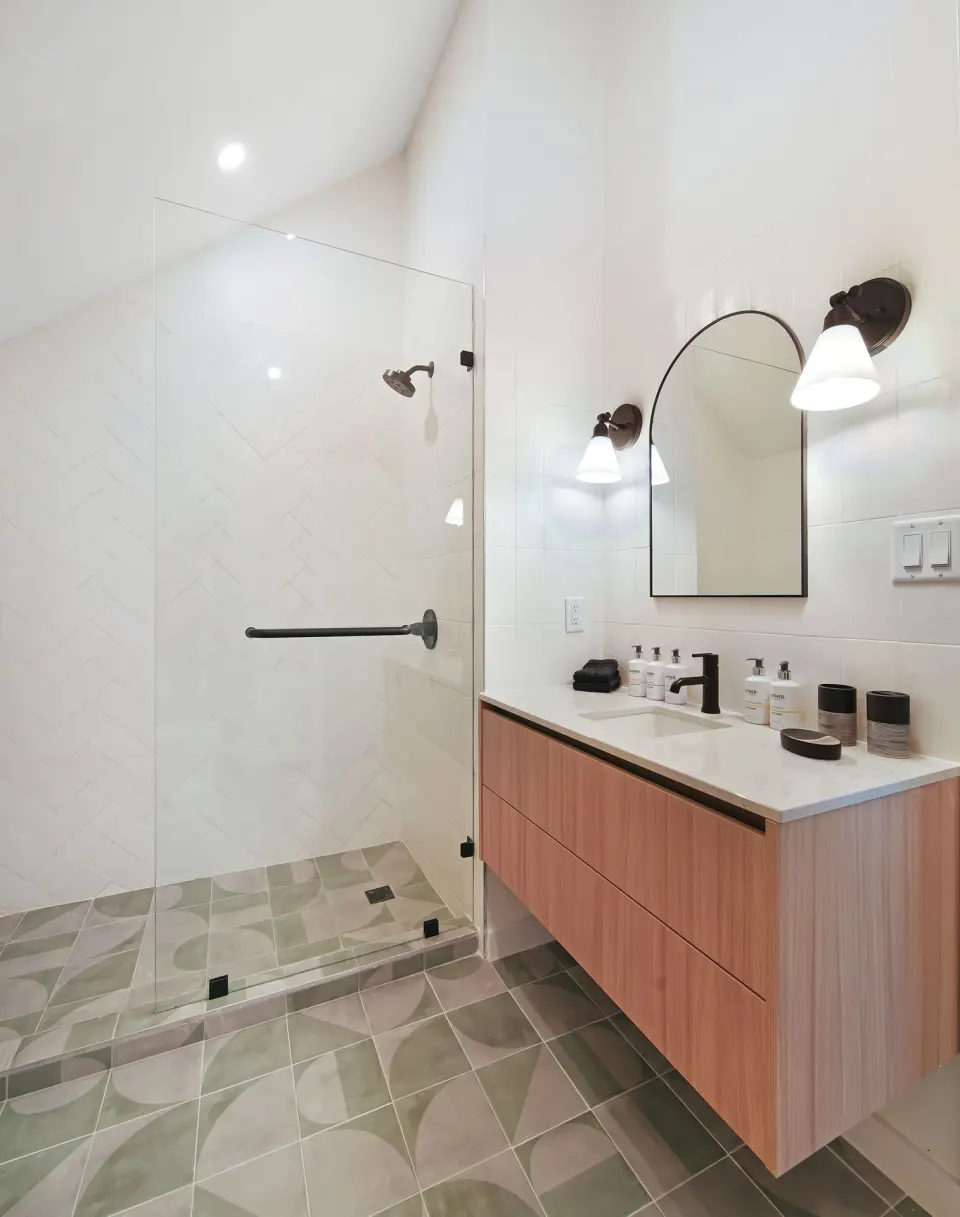 Signature Room bathroom with walk-in shower and single vanity at Cobalt Coast Resort.