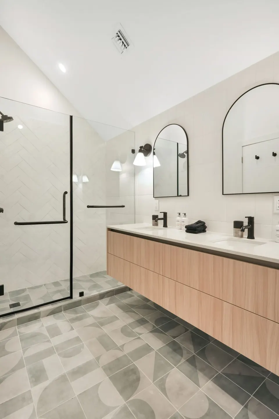 Signature Room bathroom with glass shower and double vanity at Cobalt Coast Resort.