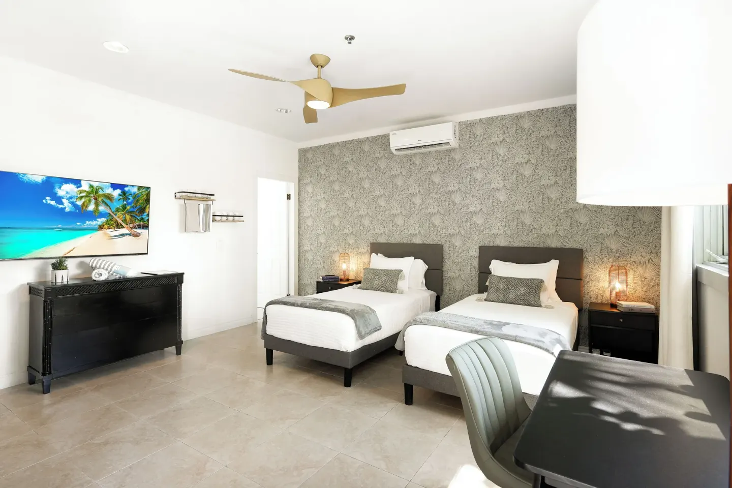 Standard Room with two twin beds, TV, dresser and desk at Cobalt Coast Resort.