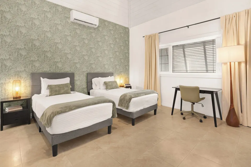 Standard Room with two twin beds, window and writing desk at Cobalt Coast Resort.