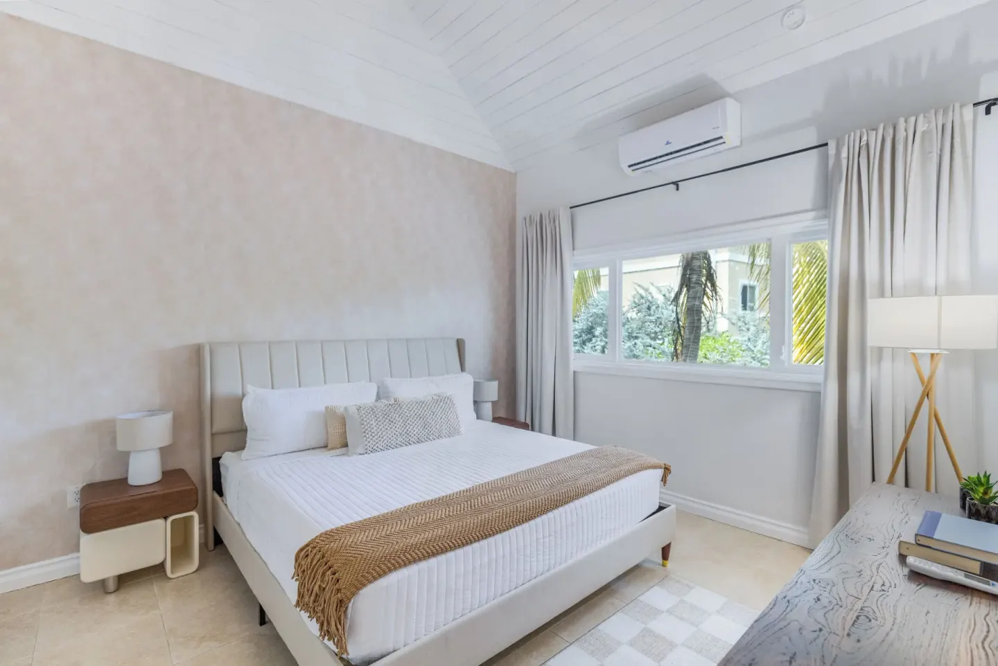 One Bedroom Suite king bed with window and soft neutral decor at Cobalt Coast Resort.