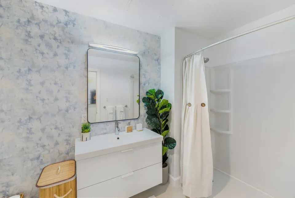 Suite one-bedroom bathroom vanity and shower at Cobalt Coast Resort.