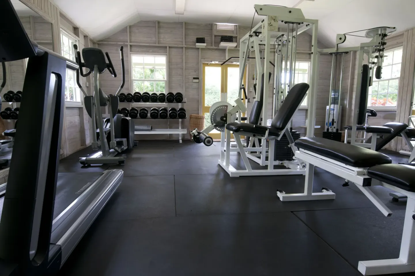 Fitness room with treadmill, weights, and strength machines at Cobblers Cove.