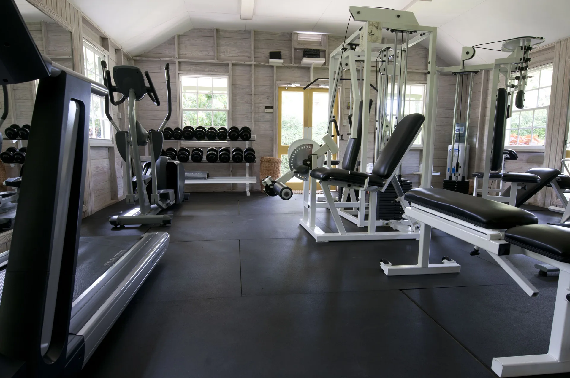 Fitness room with treadmill, weights, and strength machines at Cobblers Cove.