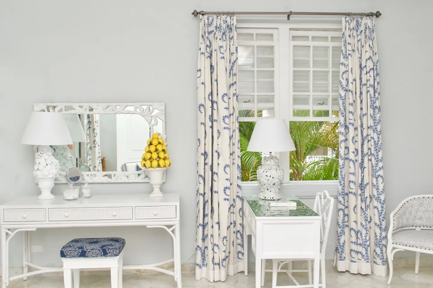 Guest room vanity and desk with blue-and-white curtains at Cobblers Cove.