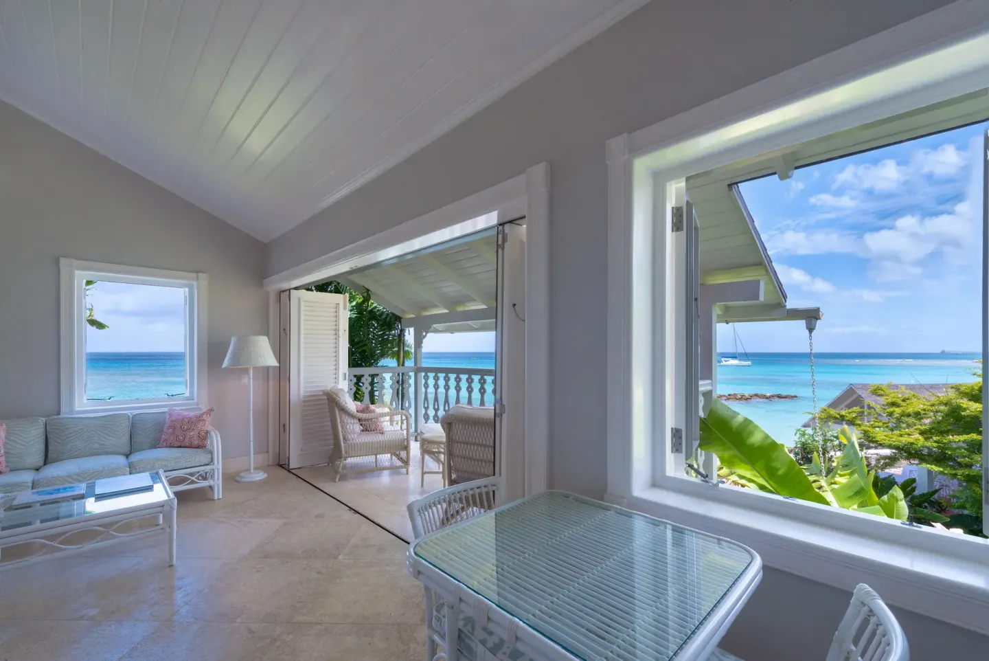 Living area with open balcony and ocean views at Cobblers Cove.