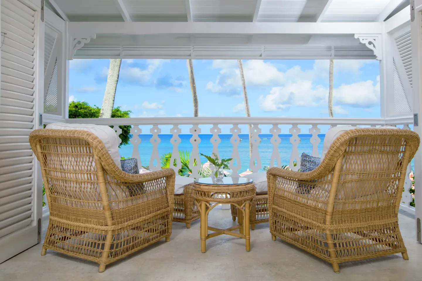 Pair of wicker chairs on a sea-view balcony at Cobblers Cove.