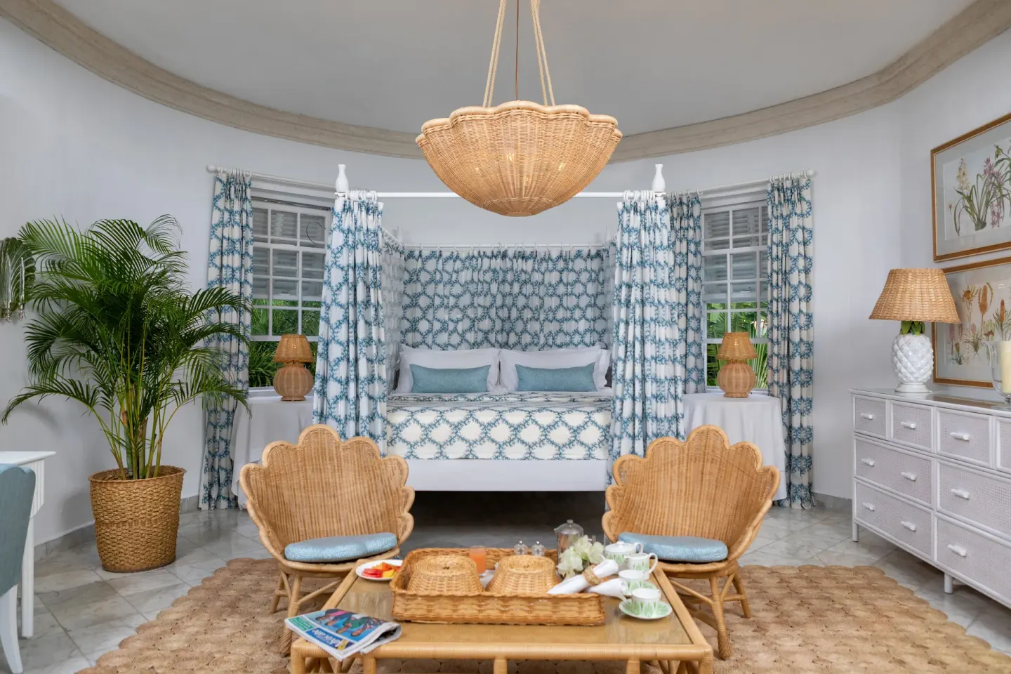 Camelot at the Great House at Cobblers Cove with king bed, wicker chairs and breakfast tray.