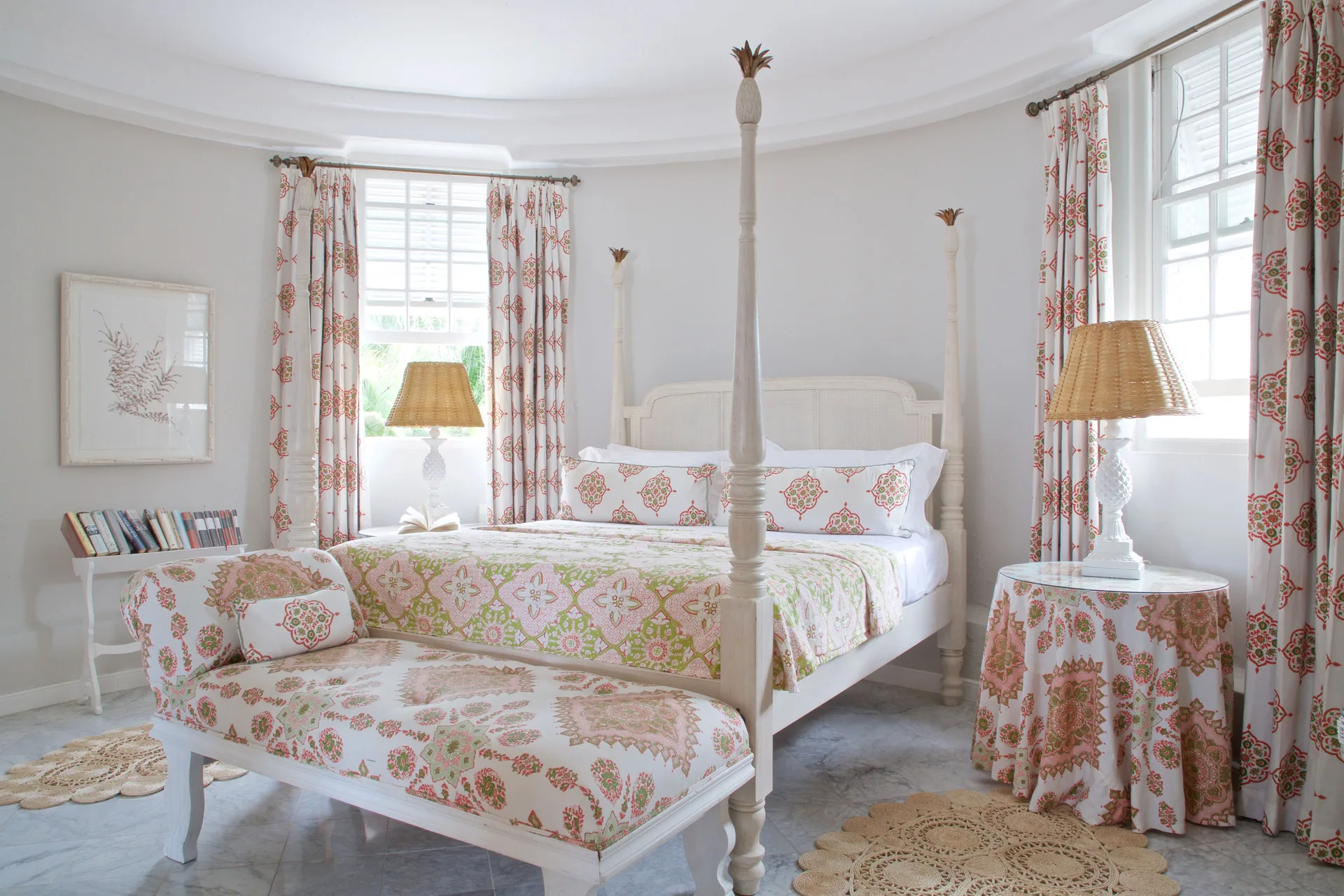 Colleton at the Great House bedroom with four-poster bed and floral chaise at Cobblers Cove.