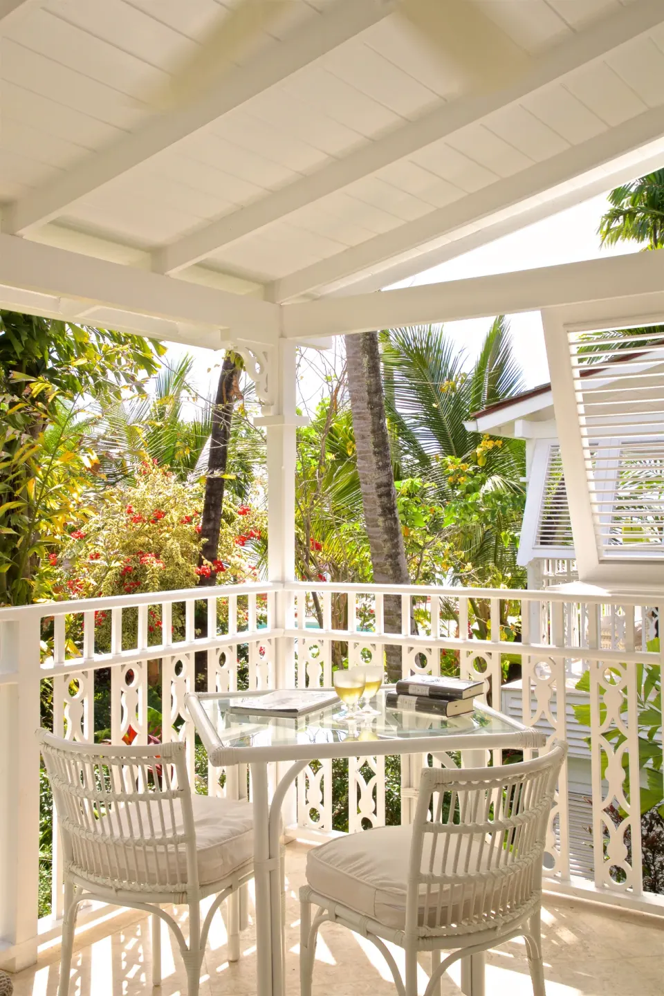 Royal Circle Suite balcony dining table among palms at Cobblers Cove.