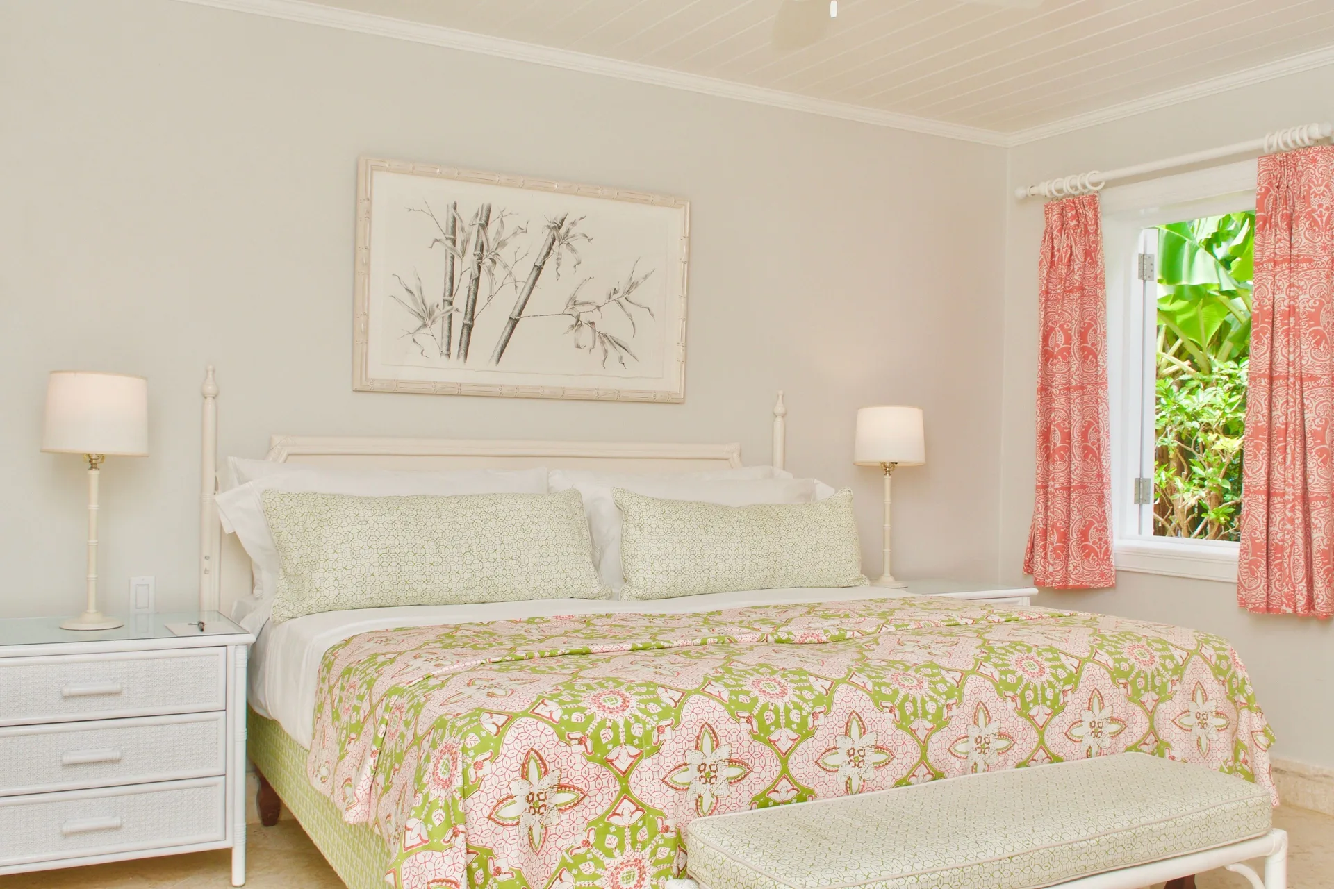 Royal Circle Suite king bed with floral bedding and garden window at Cobblers Cove.
