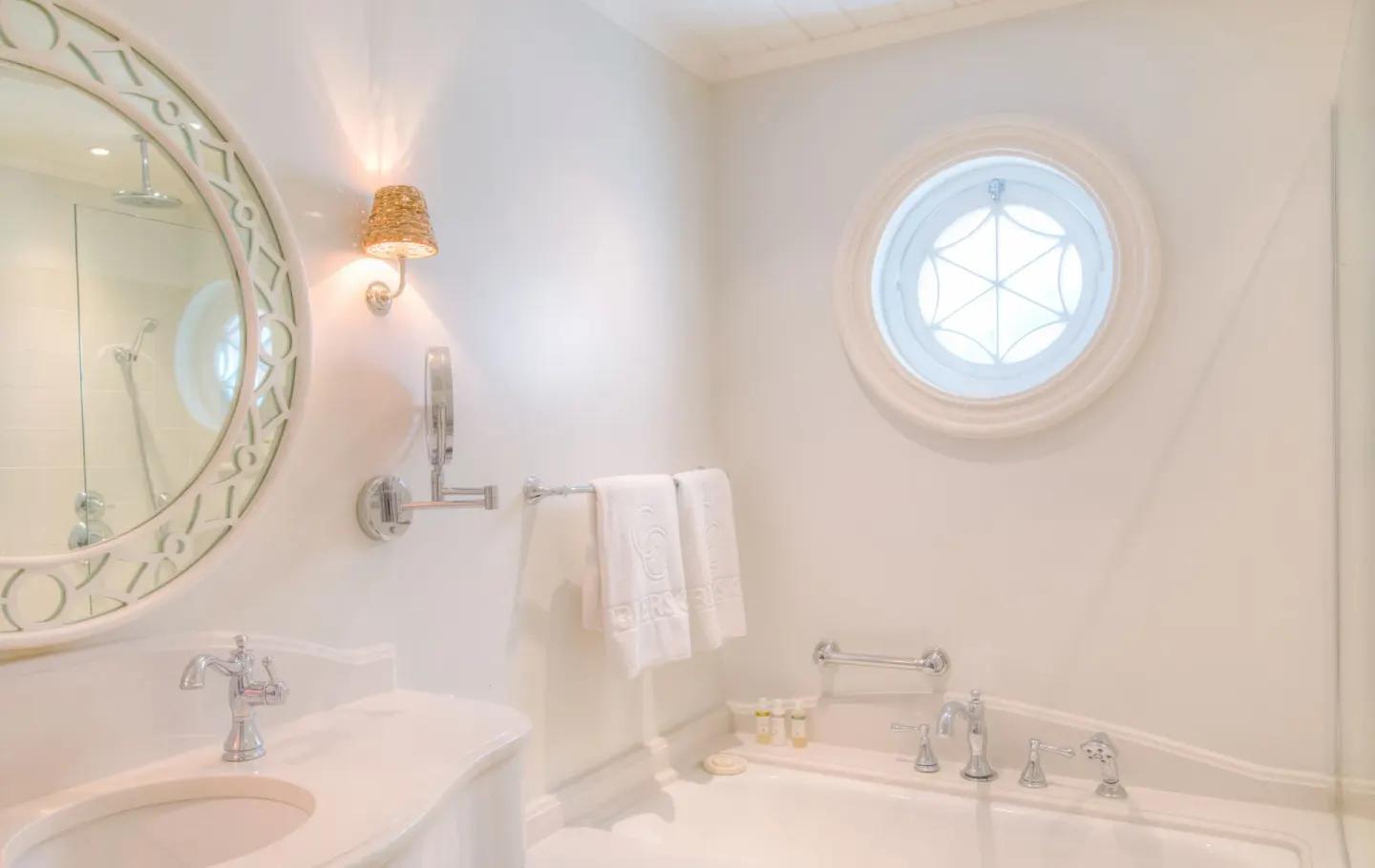 Two Bedroom Suite bathroom with bathtub, vanity and round window at Cobblers Cove.