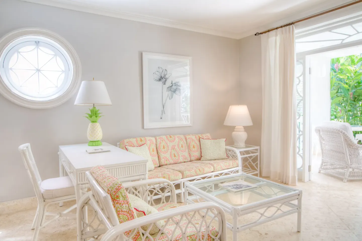 Two Bedroom Suite lounge with wicker seating and terrace doors at Cobblers Cove.