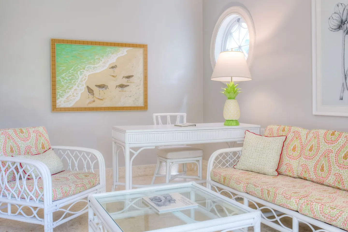 Two Bedroom Suite sitting area with sofa, desk and glass coffee table at Cobblers Cove.