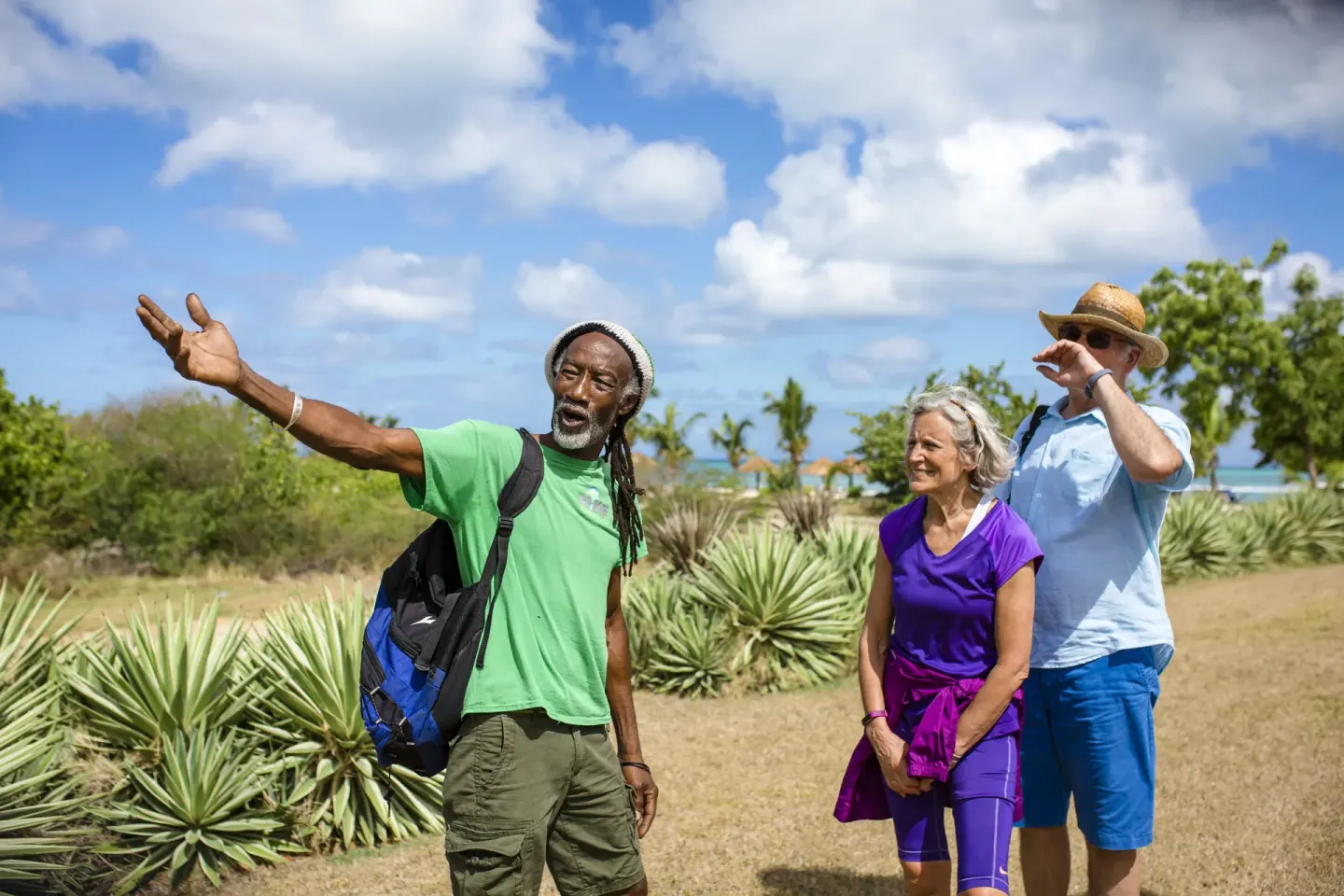 A guide points out scenery during a nature walk near Cocobay Resort.