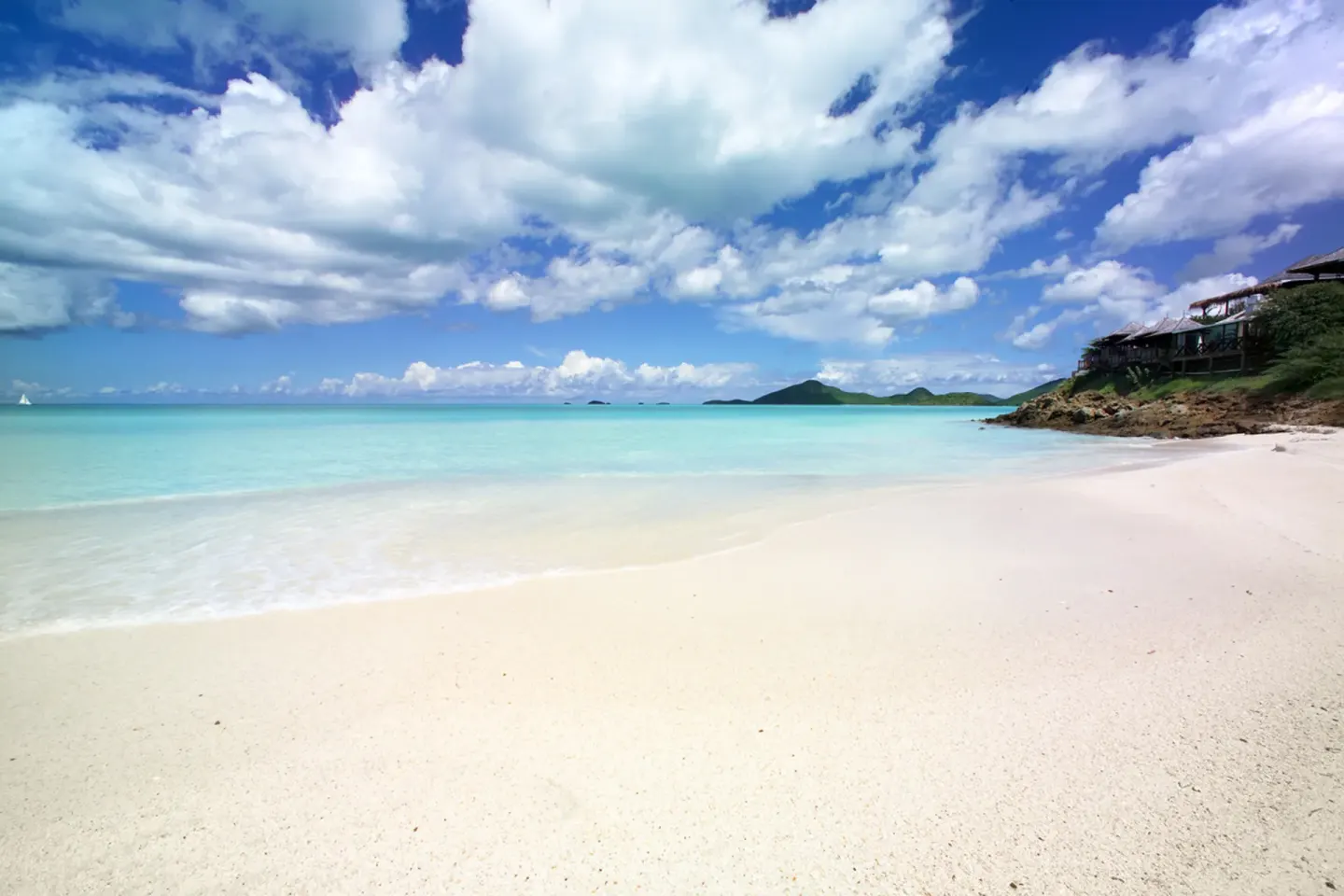 White sand beach and turquoise water near Cocobay Resort.