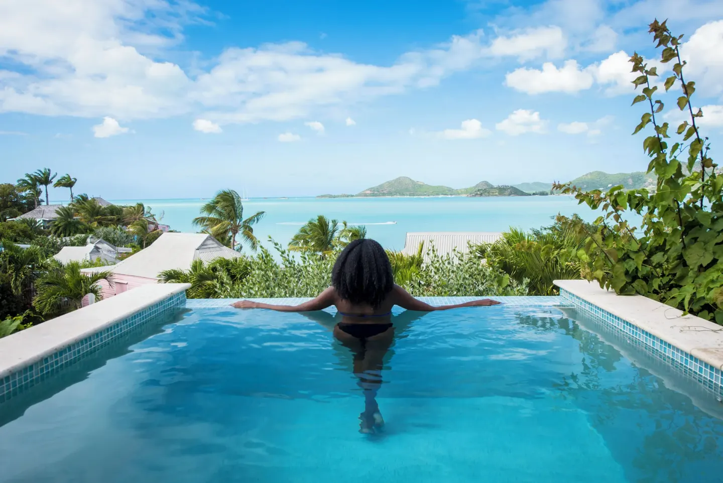 Guest in a private pool overlooking the ocean at Cocobay Resort.