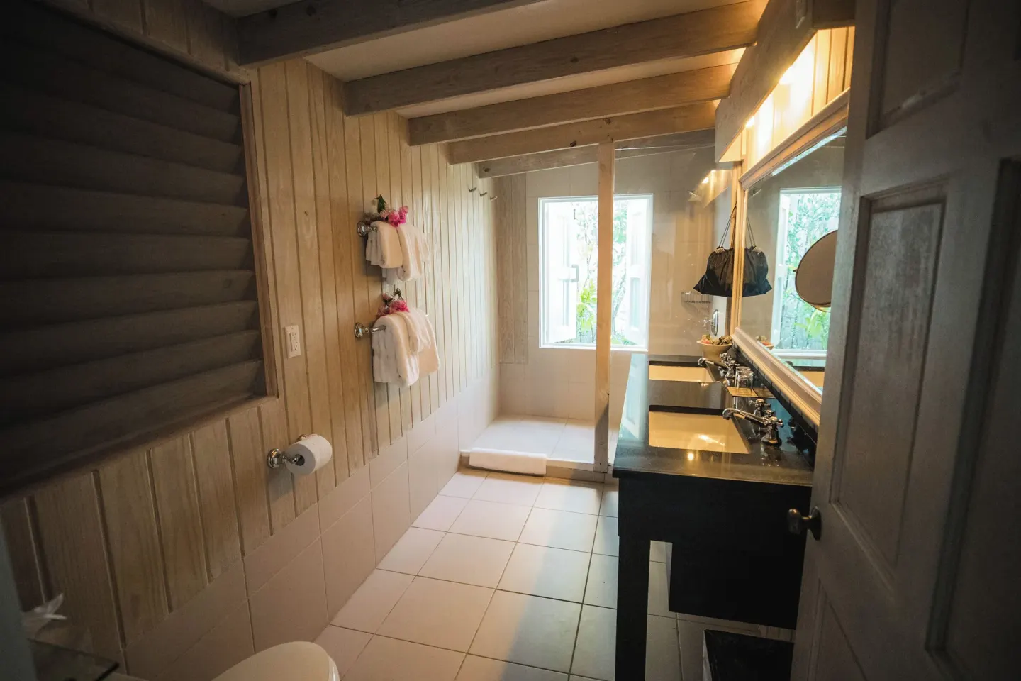 Panoramic Suite bathroom with double vanity and walk-in shower at Cocobay Resort.