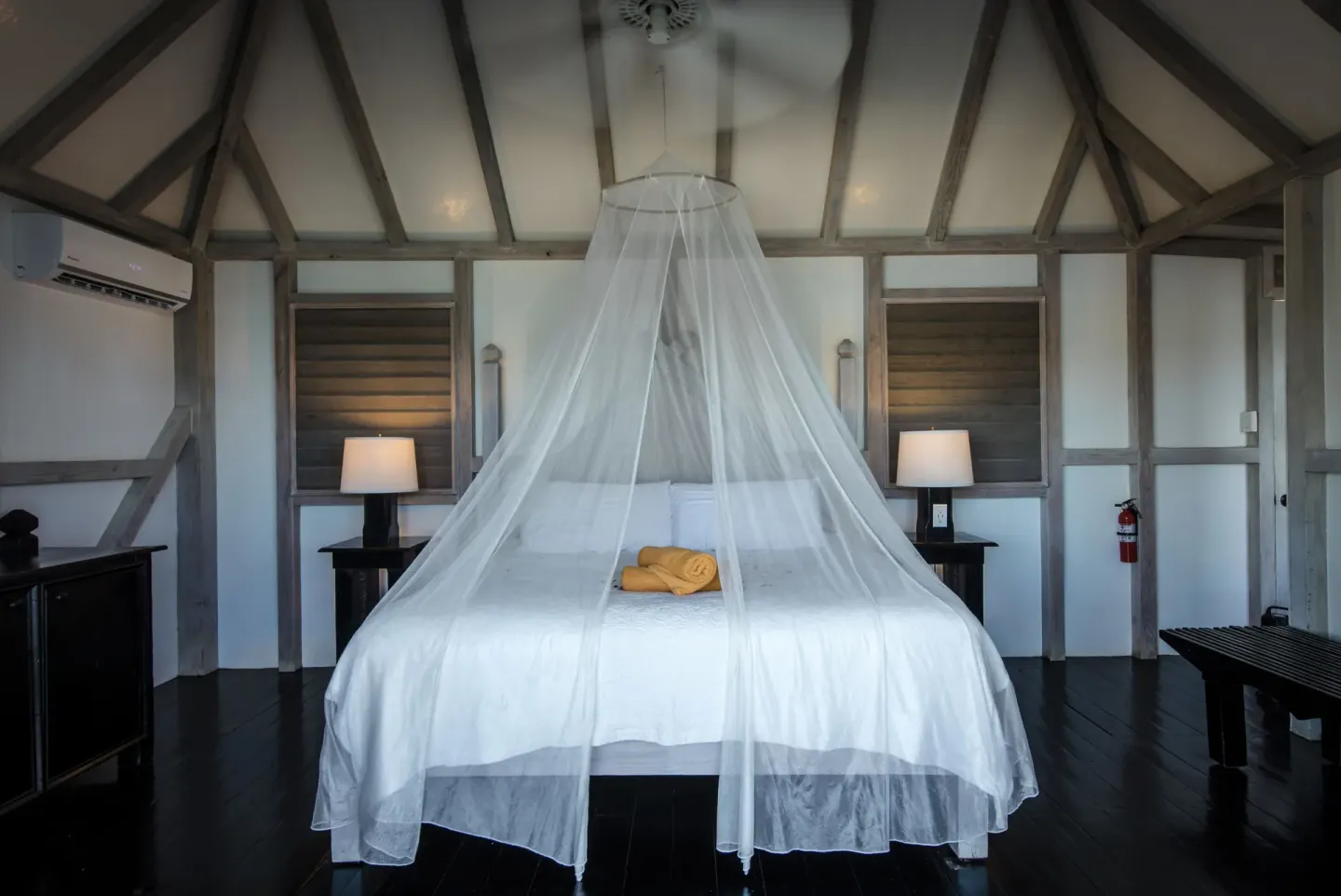Standard Cottage Garden View king bed with mosquito net at Cocobay Resort.