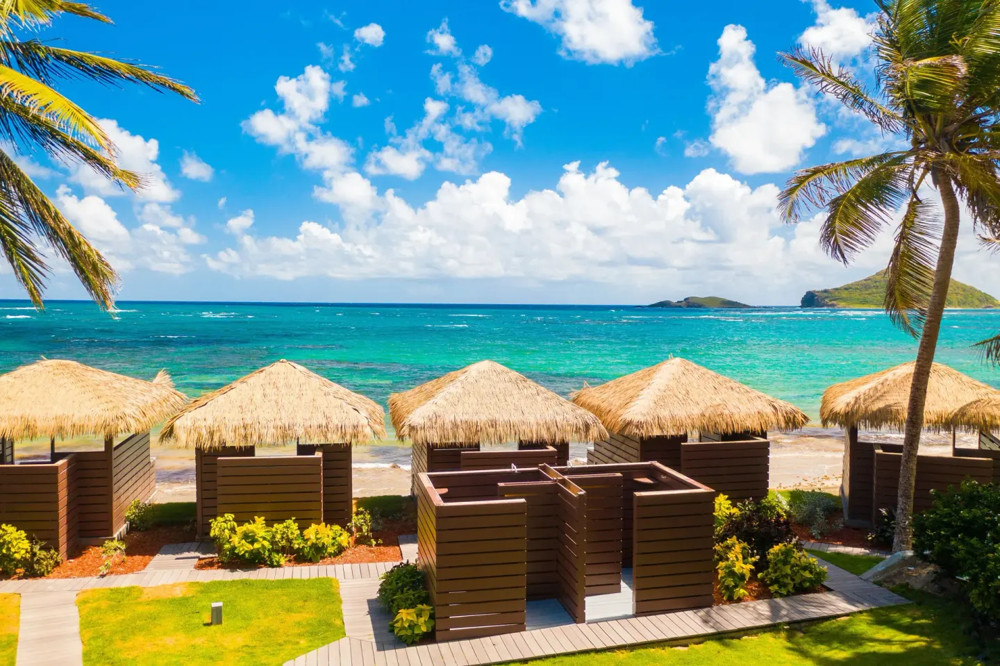 Beach cabanas and turquoise water at Coconut Bay Beach Resort & Spa.