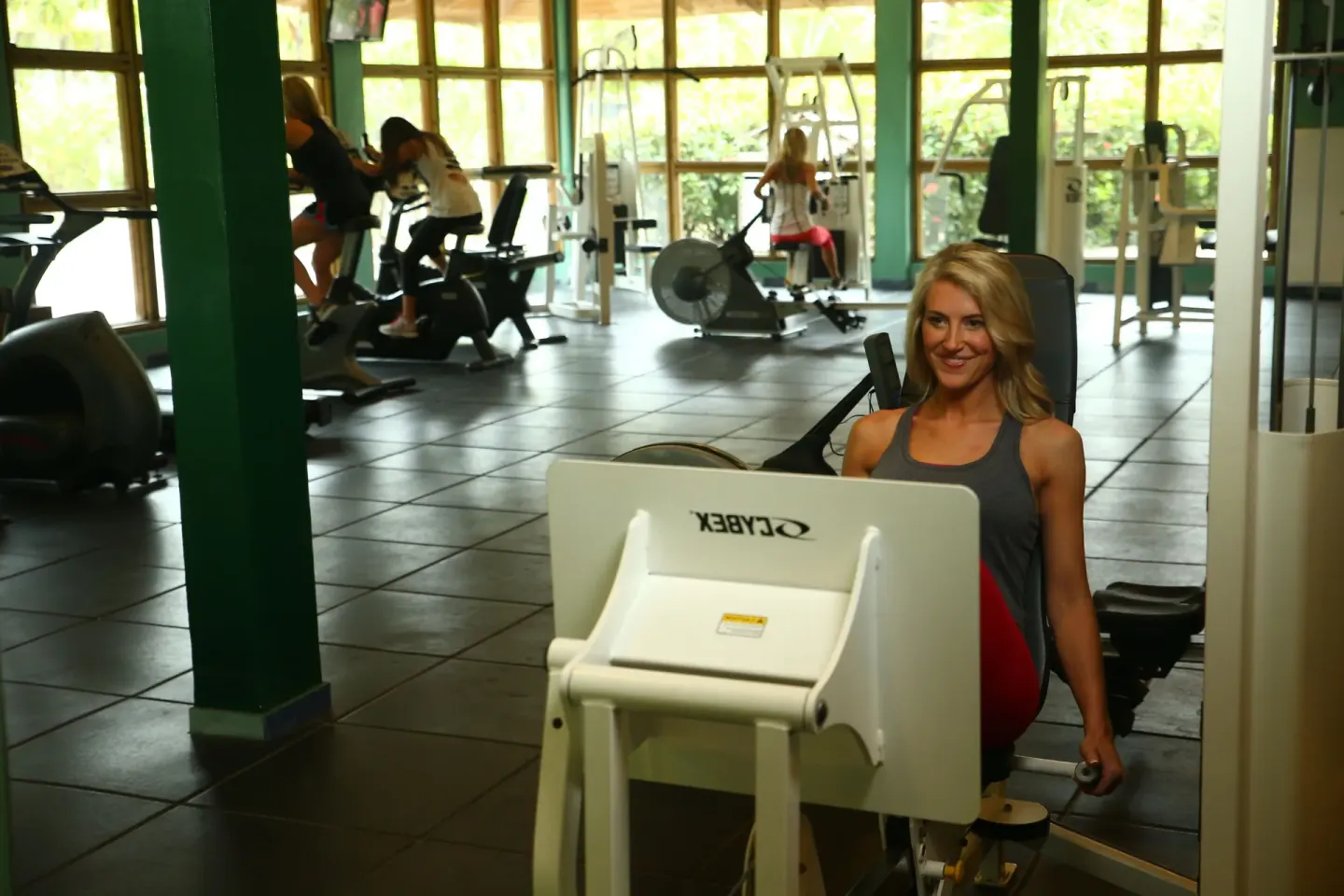 Guest uses strength equipment in the fitness center at Coconut Bay Beach Resort & Spa.