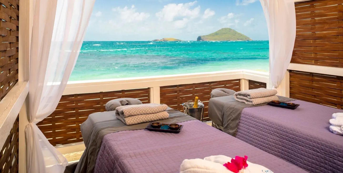 Two massage tables face the ocean at Coconut Bay Beach Resort & Spa.