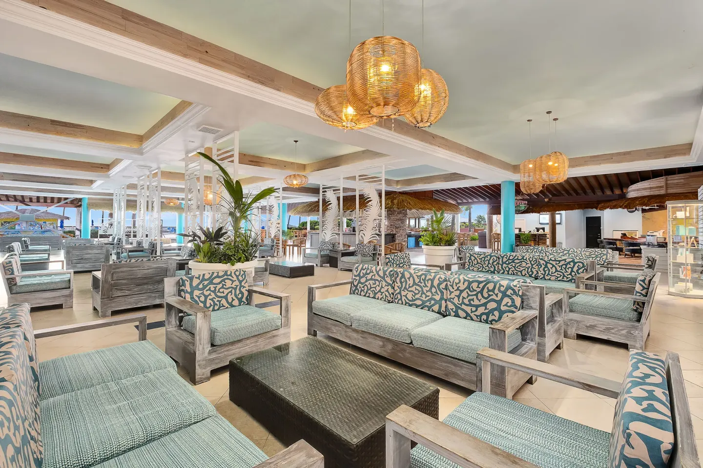 Open-air lounge seating area with woven lights at Coconut Bay Beach Resort & Spa.