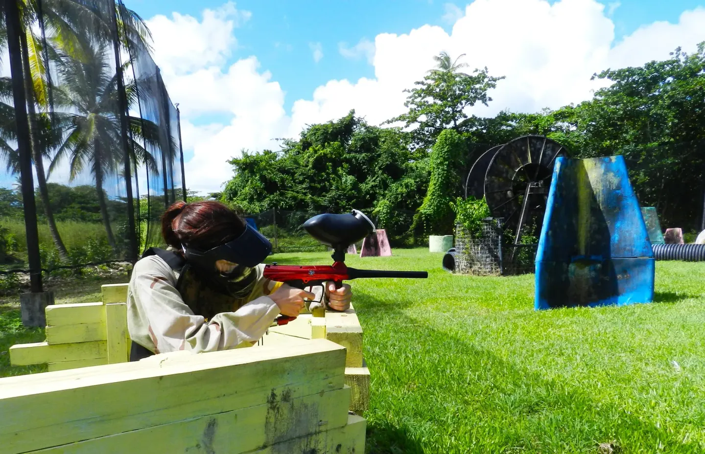 Guest plays paintball behind a barrier at Coconut Bay Beach Resort & Spa.