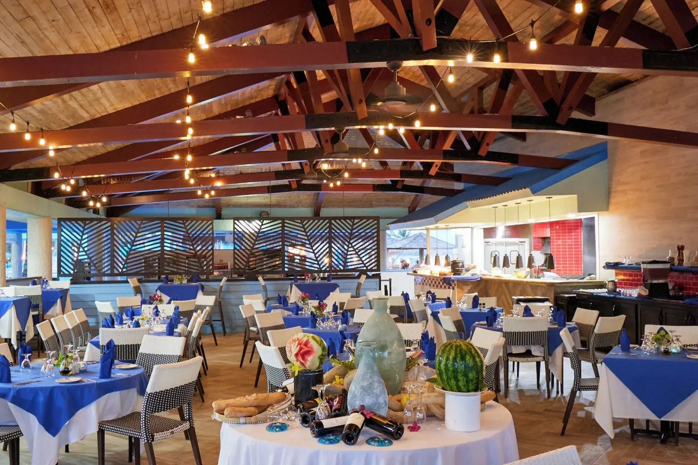 Buffet dining room with blue table settings at Coconut Bay Beach Resort & Spa.